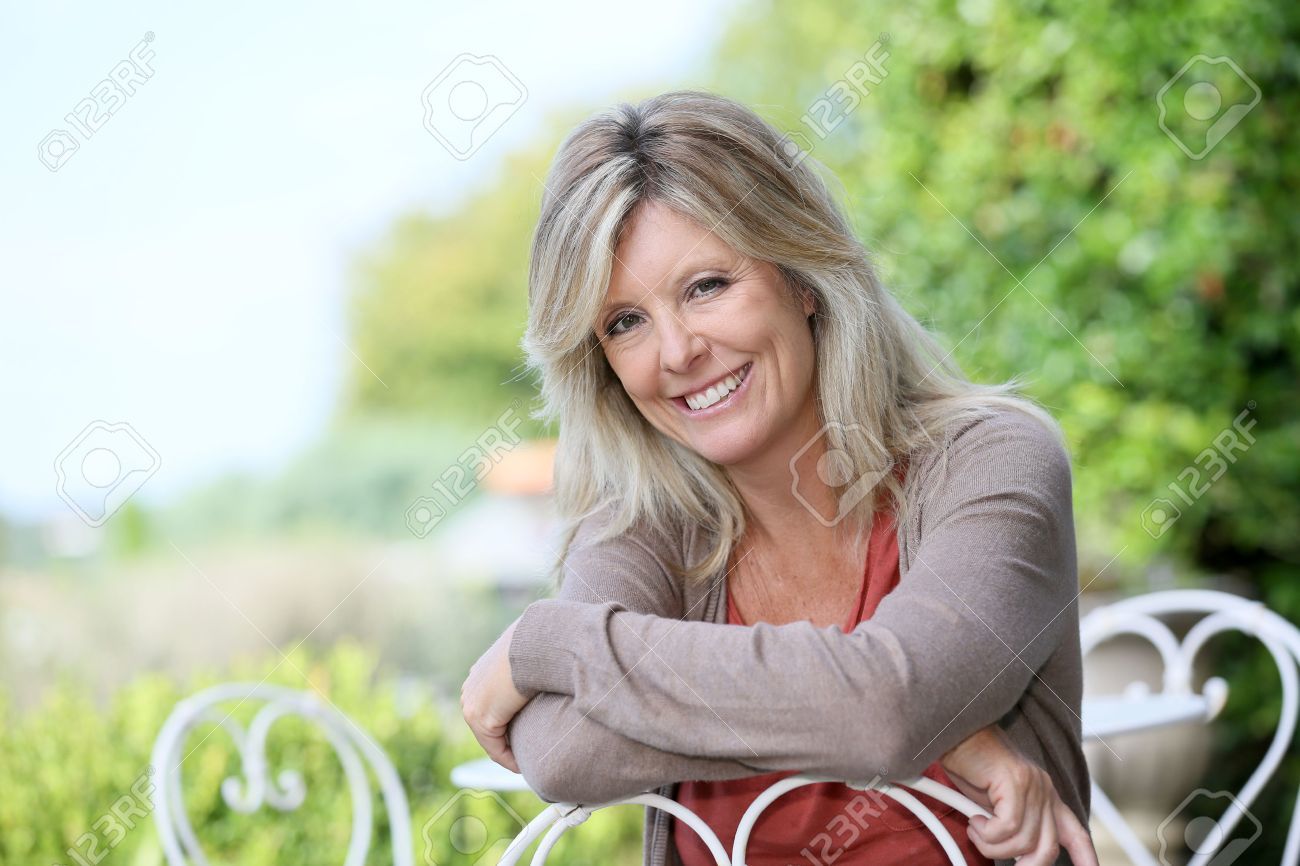 31801011-portrait-of-smiling-mature-blond-woman-in-garden