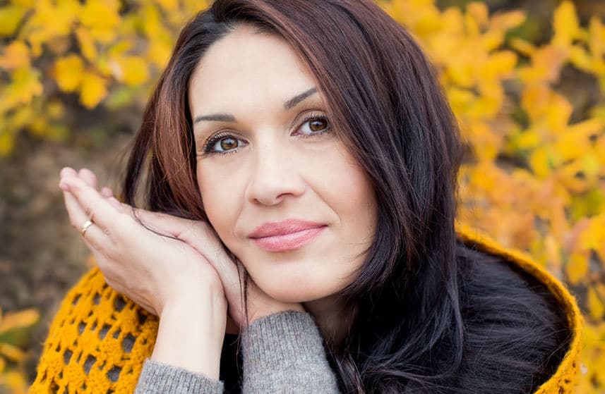 34088658 - portrait of beautiful middle age woman walking outdoors in autumn